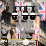 Professionals discussing facial recognition technology in a meeting.