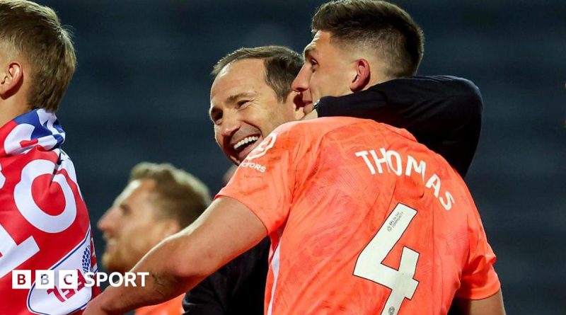 Coventry City fans celebrate their team's return to the Premier League with joy.
