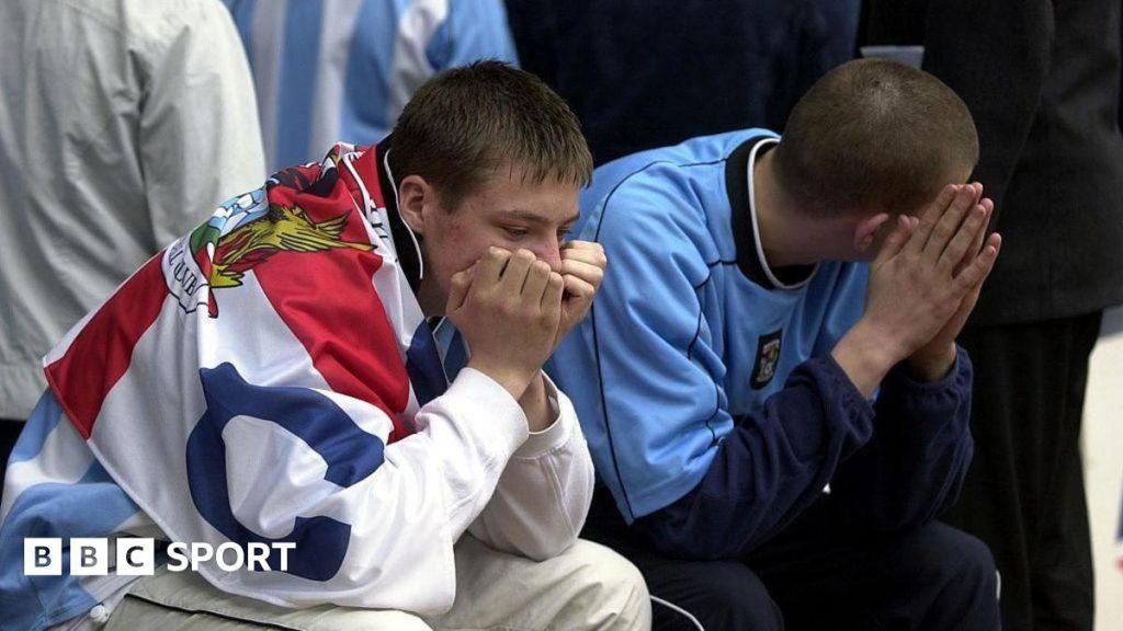 Celebration of Coventry City football fans in a packed stadium.
