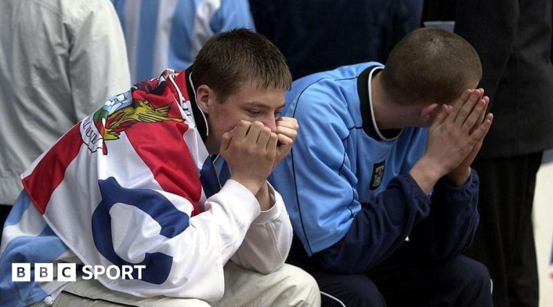 Celebration of Coventry City football fans in a packed stadium.