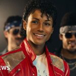 Film crew discussing a Michael Jackson biopic on set, showcasing a professional atmosphere.