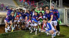 Crystal Palace players celebrating their Conference League success in a stadium.