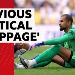 Football match scene showing players and referee addressing tactical stoppages in football.