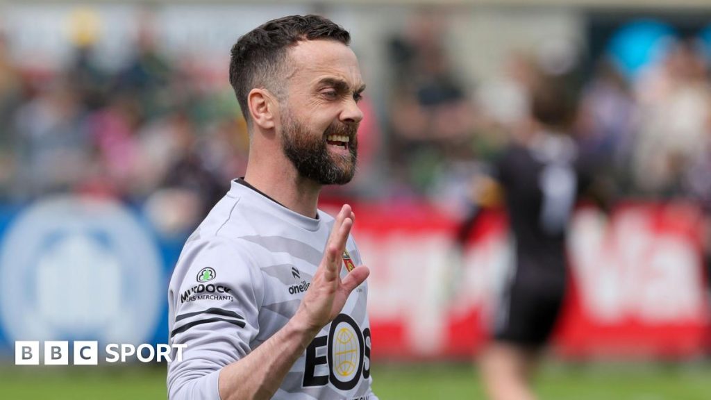 Down Championship victory scene with players showcasing teamwork and excitement in a football match.