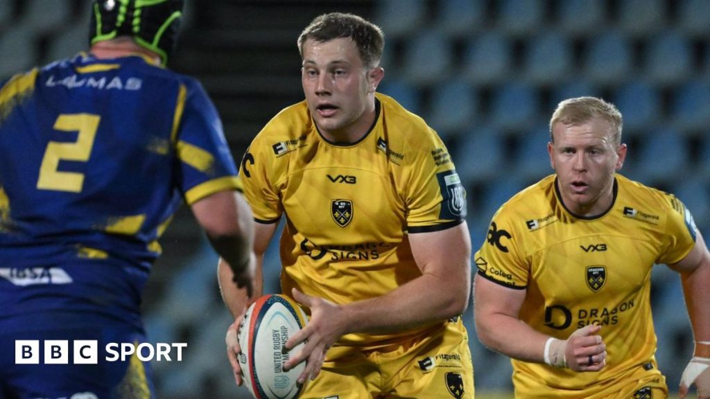 Dragons away victory in rugby match showing players in action.