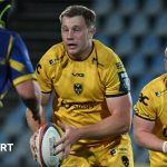 Dragons away victory in rugby match showing players in action.