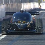 A driverless car showcasing new technology on a busy urban street.