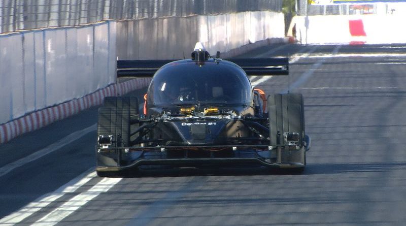 A driverless car showcasing new technology on a busy urban street.