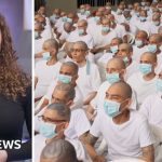 Courtroom scene showing the El Salvador gang trial with remote participants.