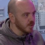 A diverse group of men discussing emotions in a professional setting.