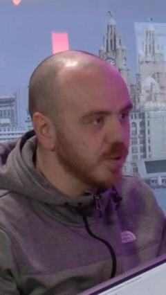 A diverse group of men discussing emotions in a professional setting.