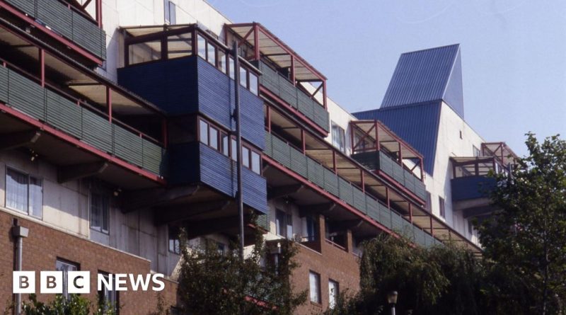 Diverse professionals discussing Byker Wall energy bills in an office.