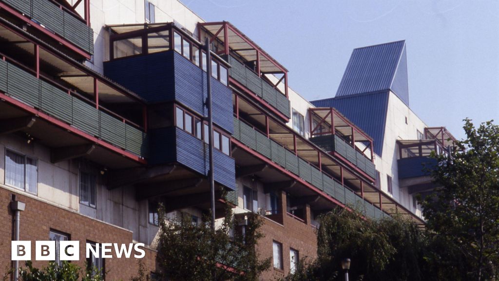 Diverse professionals discussing Byker Wall energy bills in an office.