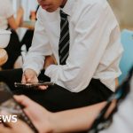 Students engaged in learning without phones in a classroom setting.