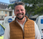 People in Jersey engaging with driverless cars, highlighting future transportation solutions.