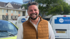 People in Jersey engaging with driverless cars, highlighting future transportation solutions.