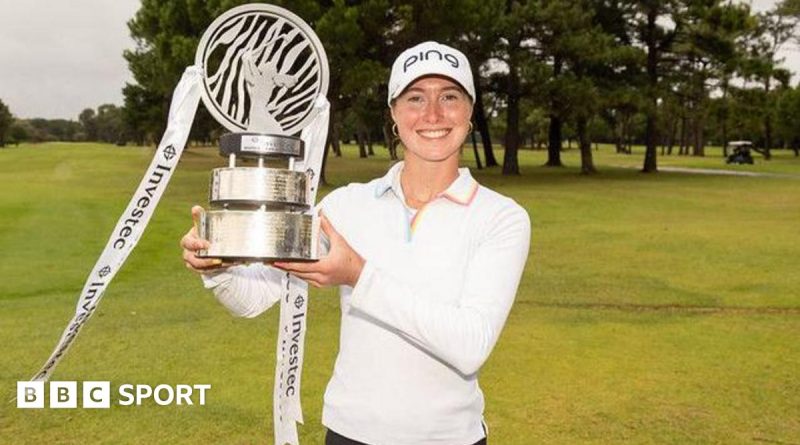 Esme Hamilton celebrating her European Tour victory with a trophy on the golf course.