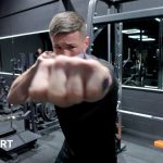 Fighters in a gym practicing bare-knuckle boxing safety techniques.