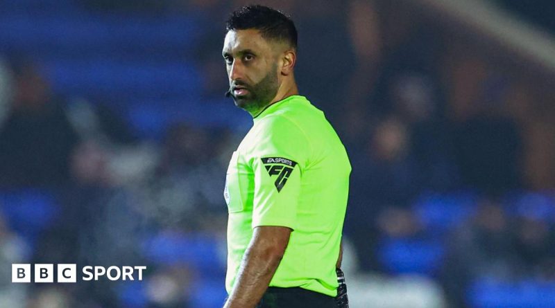 A football referee officiates a match, emphasizing discrimination against referee issues.
