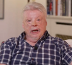 A diverse group in formal attire discussing the Falklands veteran issue.