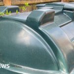 A group of professionals discussing heating oil assistance in an office.