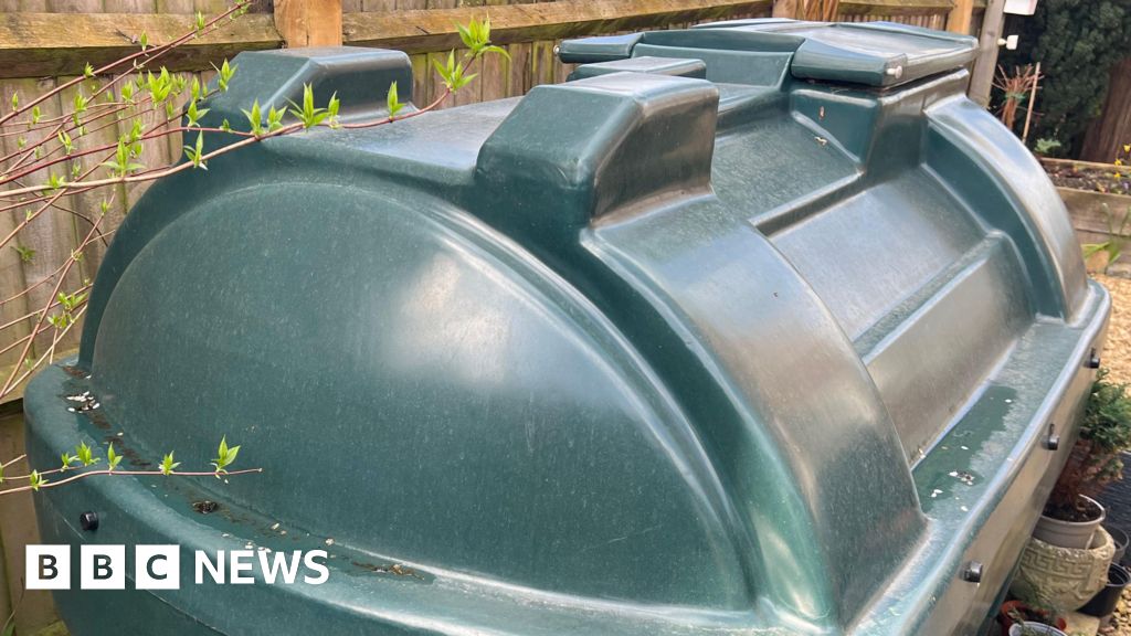 A group of professionals discussing heating oil assistance in an office.