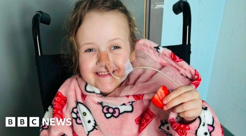 A family planning a Disney trip for a girl with a tumor, smiling together.