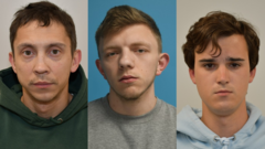 A concerned family member stands near a damaged house after an arson attack.