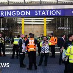 Scene at Farringdon Station showing gas leak response and travelers.