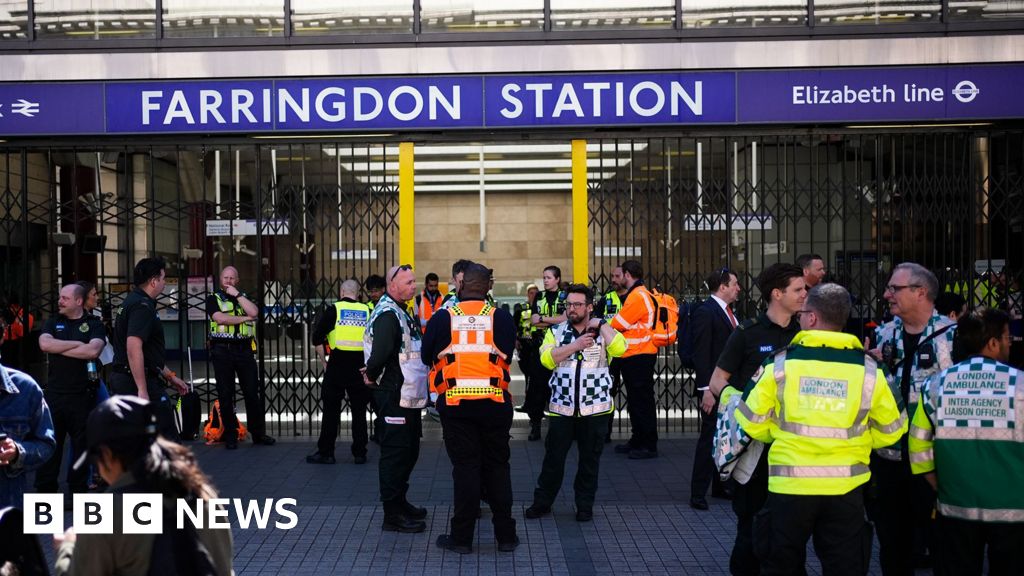 Scene at Farringdon Station showing gas leak response and travelers.