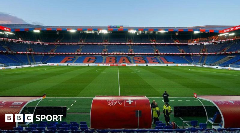 Emergency responders at the FC Basel stadium fire scene, emphasizing safety and damage assessment.