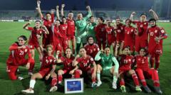 Afghan women footballers celebrating their return to international sports.