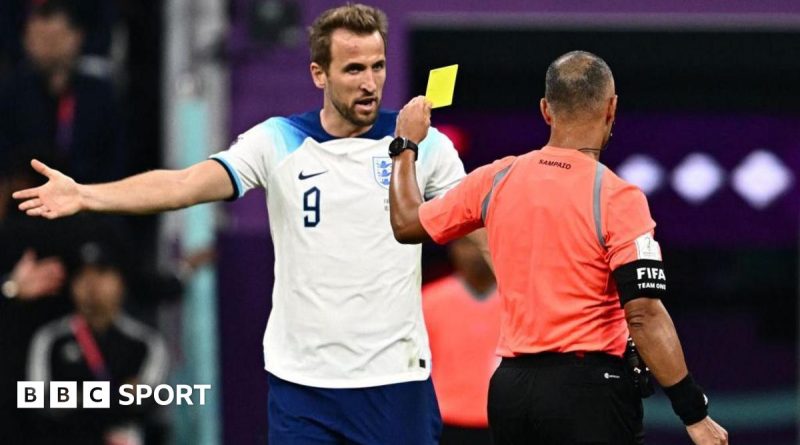 Diverse soccer players discussing strategies during the World Cup yellow card amnesty.
