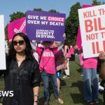 Women and men in conservative attire debating the Assisted Dying Bill in a formal chamber.