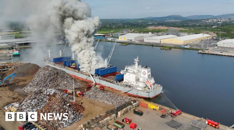 Firefighters tackling a fire on a cargo ship carrying scrap metal.