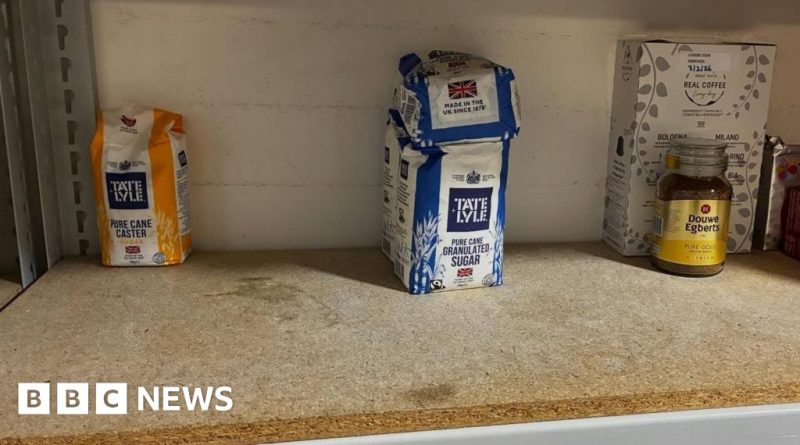 People organizing food supplies at a food bank, highlighting increased food bank demand.