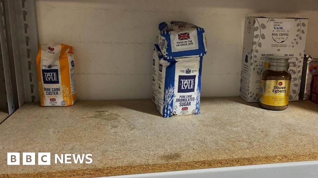 People organizing food supplies at a food bank, highlighting increased food bank demand.