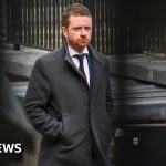 A professional office meeting scene with Morgan McSweeney allegations discussed.