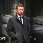 A serious meeting regarding the Mandelson appointment testimony in a professional setting.