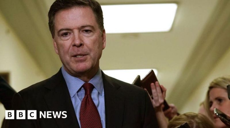 Professionals discussing Comey charges related to Trump threat in a meeting.