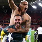 Alfie Whiteman at a photography exhibition, showcasing his work.