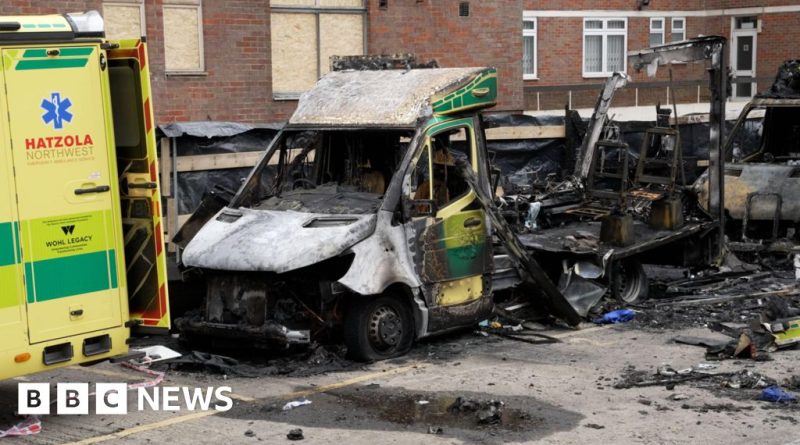 Four individuals in professional attire outside a courtroom discussing the Jewish charity ambulances arson case.