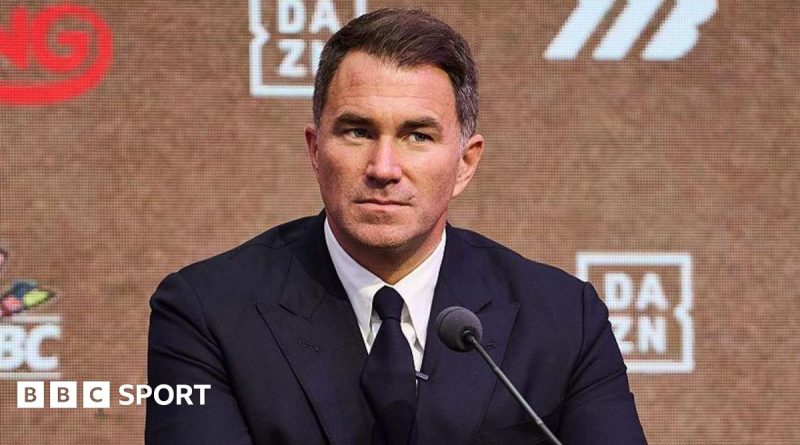 Excited fans in a boxing arena waiting for the Fury Joshua fight.