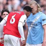 Referees discuss the Gabriel headbutt VAR decision during a match.