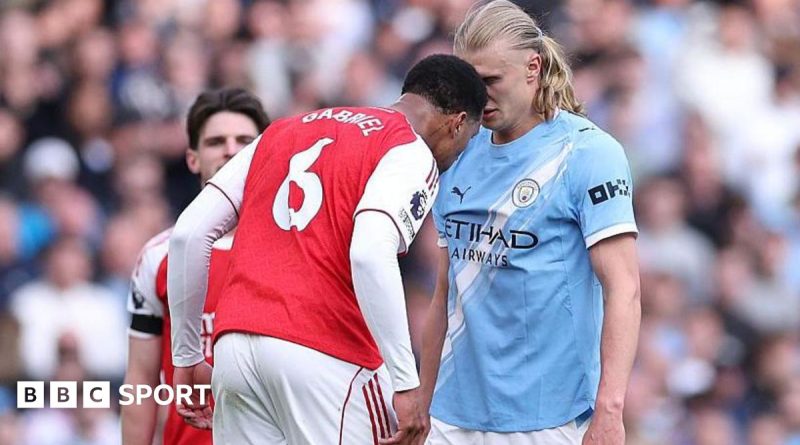 Referees discuss the Gabriel headbutt VAR decision during a match.