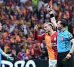 Group of professionals discussing Galatasaray referee criticism in an office.