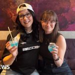 A group of young adults enjoying Gen Z cocktails in a lively bar setting.