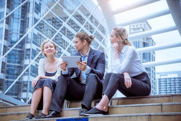 Young adults discussing Germany military approval in a modern office.