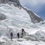 Climbers evaluating an ice block on the Everest climbing route.