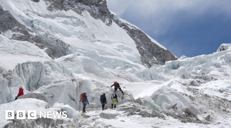 Climbers evaluating an ice block on the Everest climbing route.